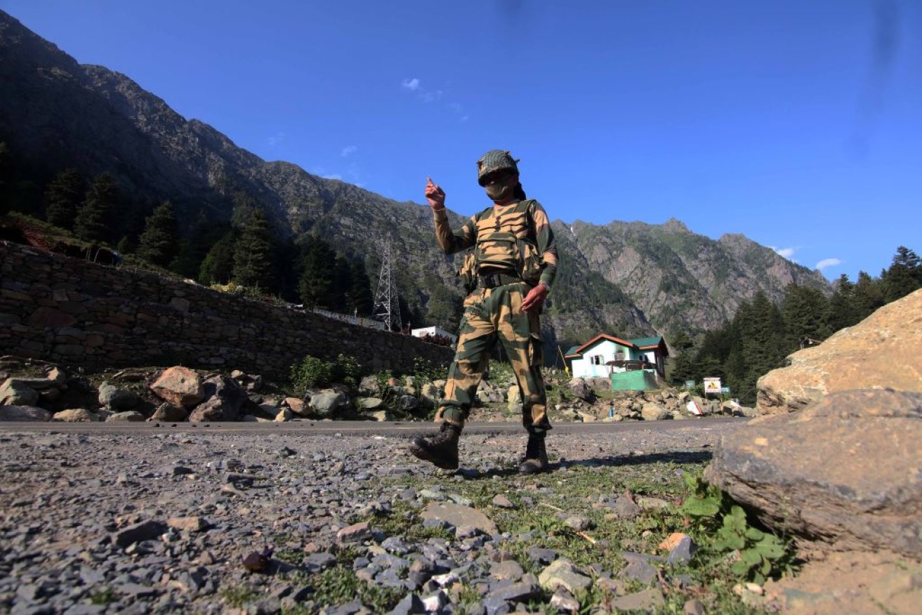 An Indian Border Security Force soldier walks near a check post along the Srinagar-Leh National highway.