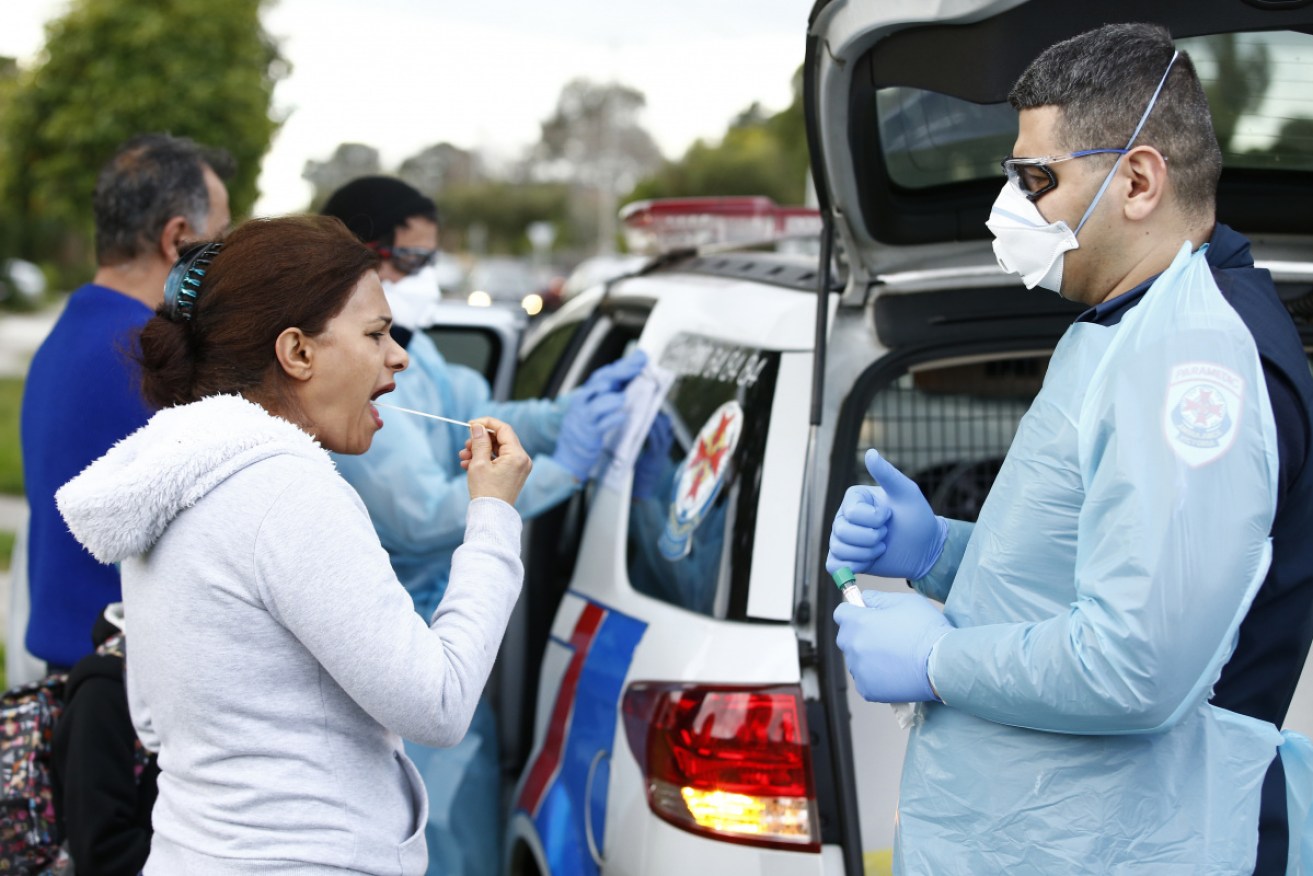 Paramedics perform COVID-19 tests in Broadmeadows on Thursday after doorknocking residents in the Melbourne suburb.  