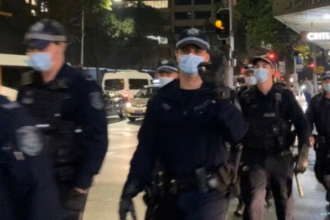 A protestor who filmed a police officer making a controversial gesture has slammed NSW Police's excuse.