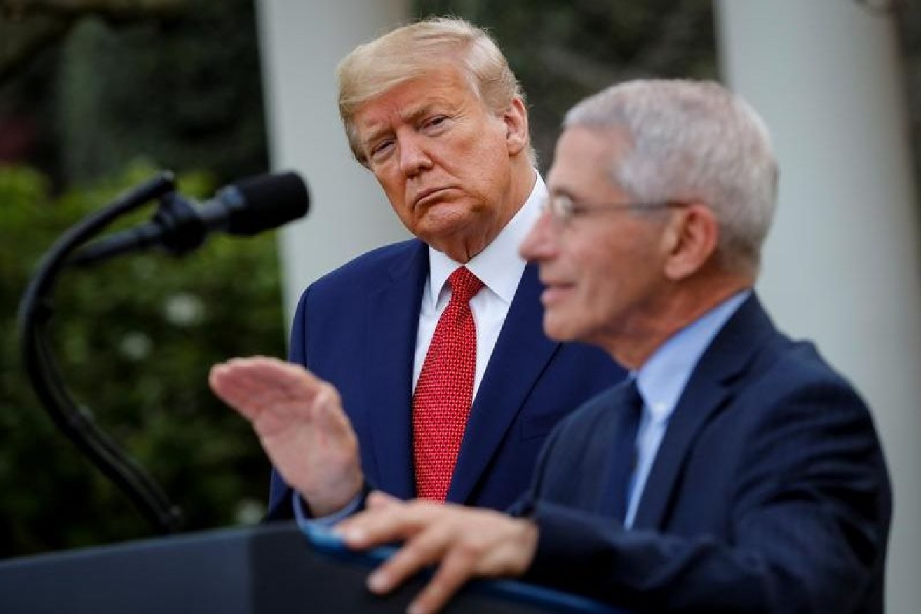Dr Fauci with Mr Trump at the White House in July.