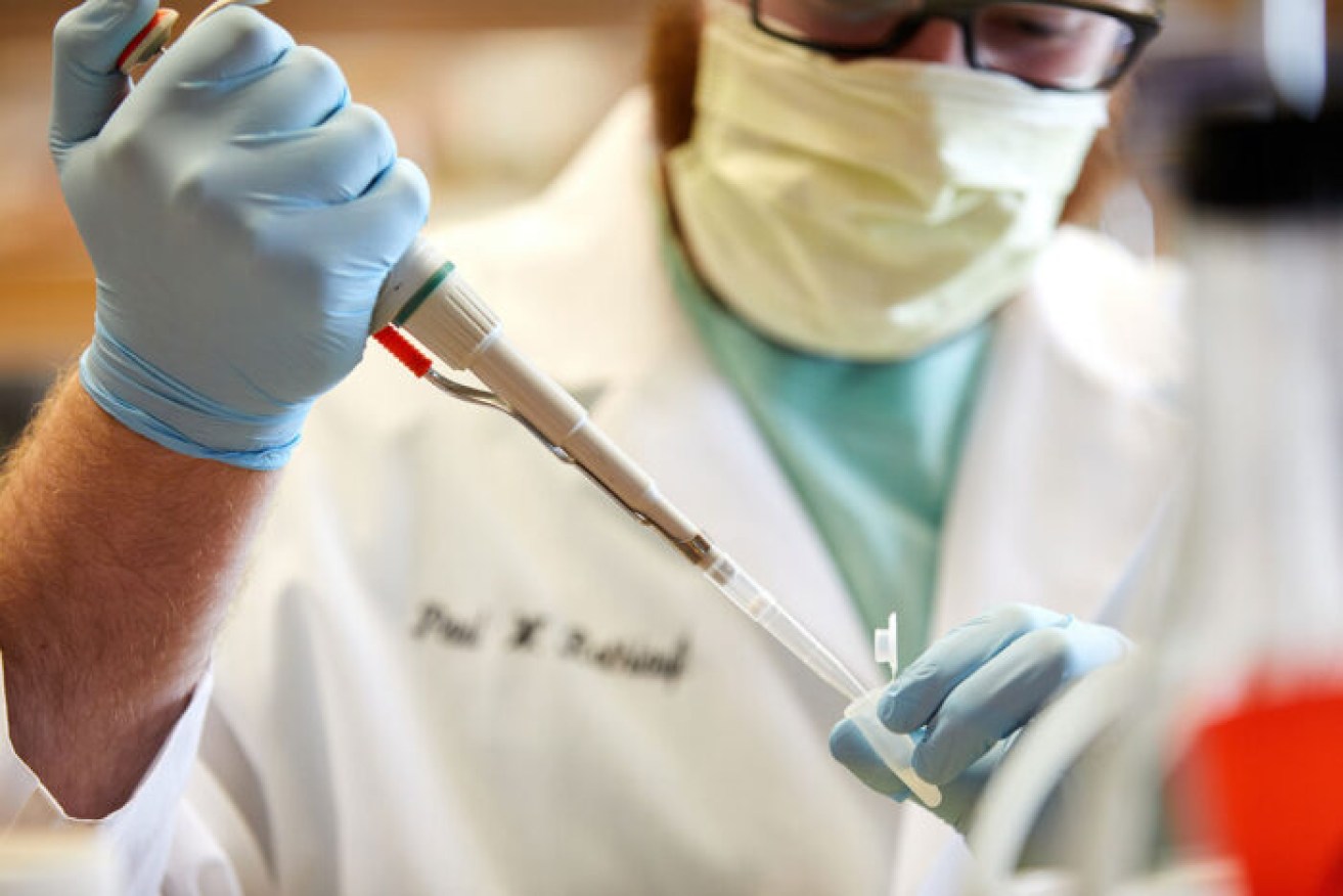 Paul Rothlauf, a visiting scientist at Washington University School of Medicine, works with the new lab-made virus.