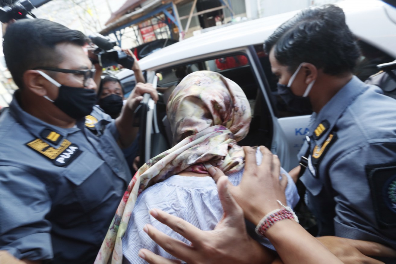 Sara Connor is escorted to an immigration car after her release from prison in Bali on Thursday.