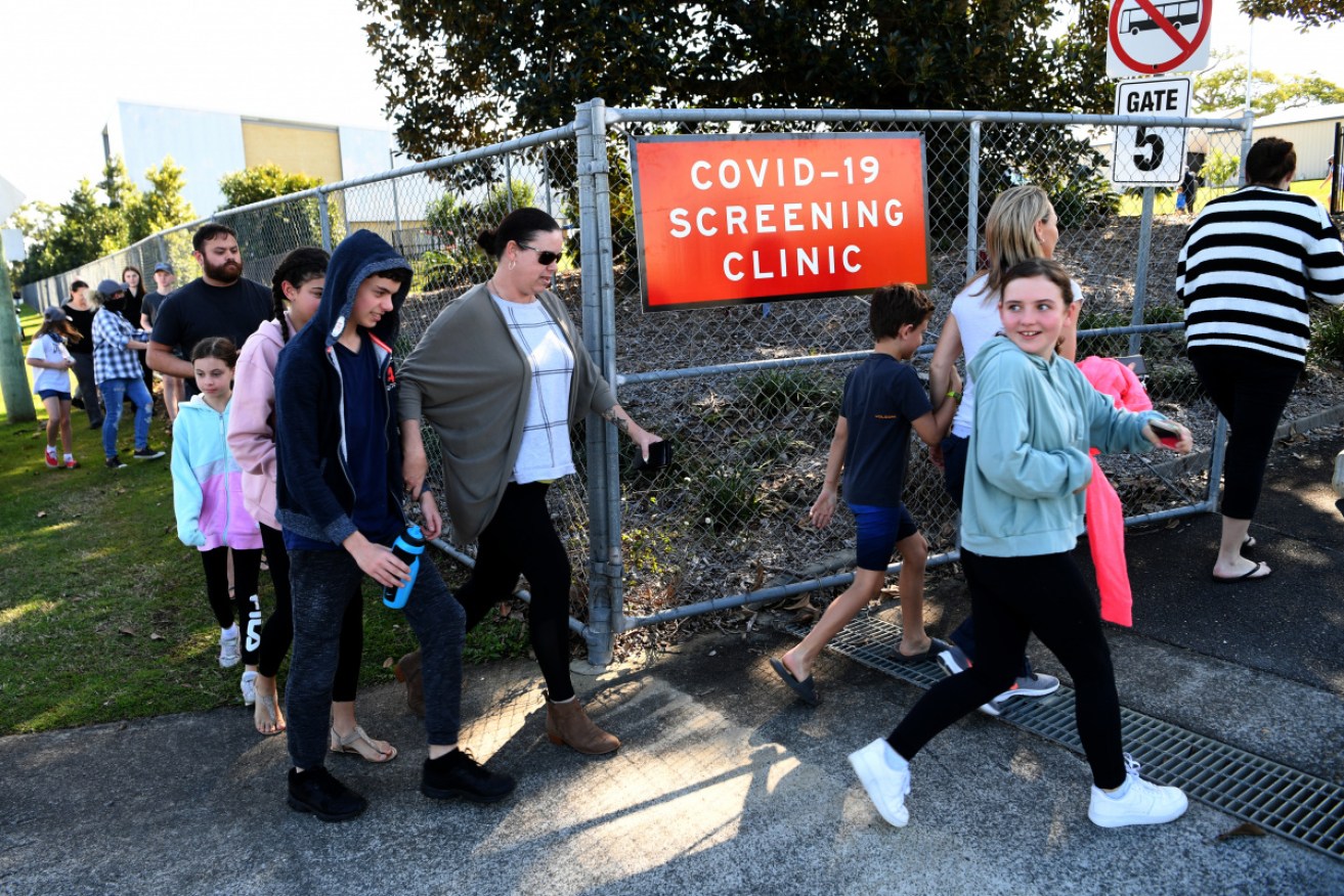 People arrive at Parklands Christian College for COVID testing after Wednesday's revelations.