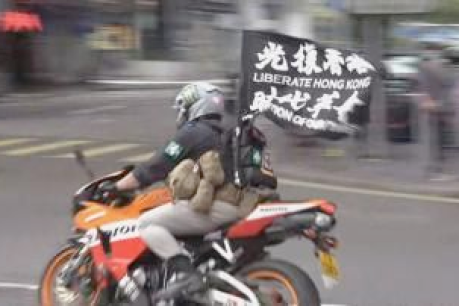 Motorcyclist crashes into police at HK protest