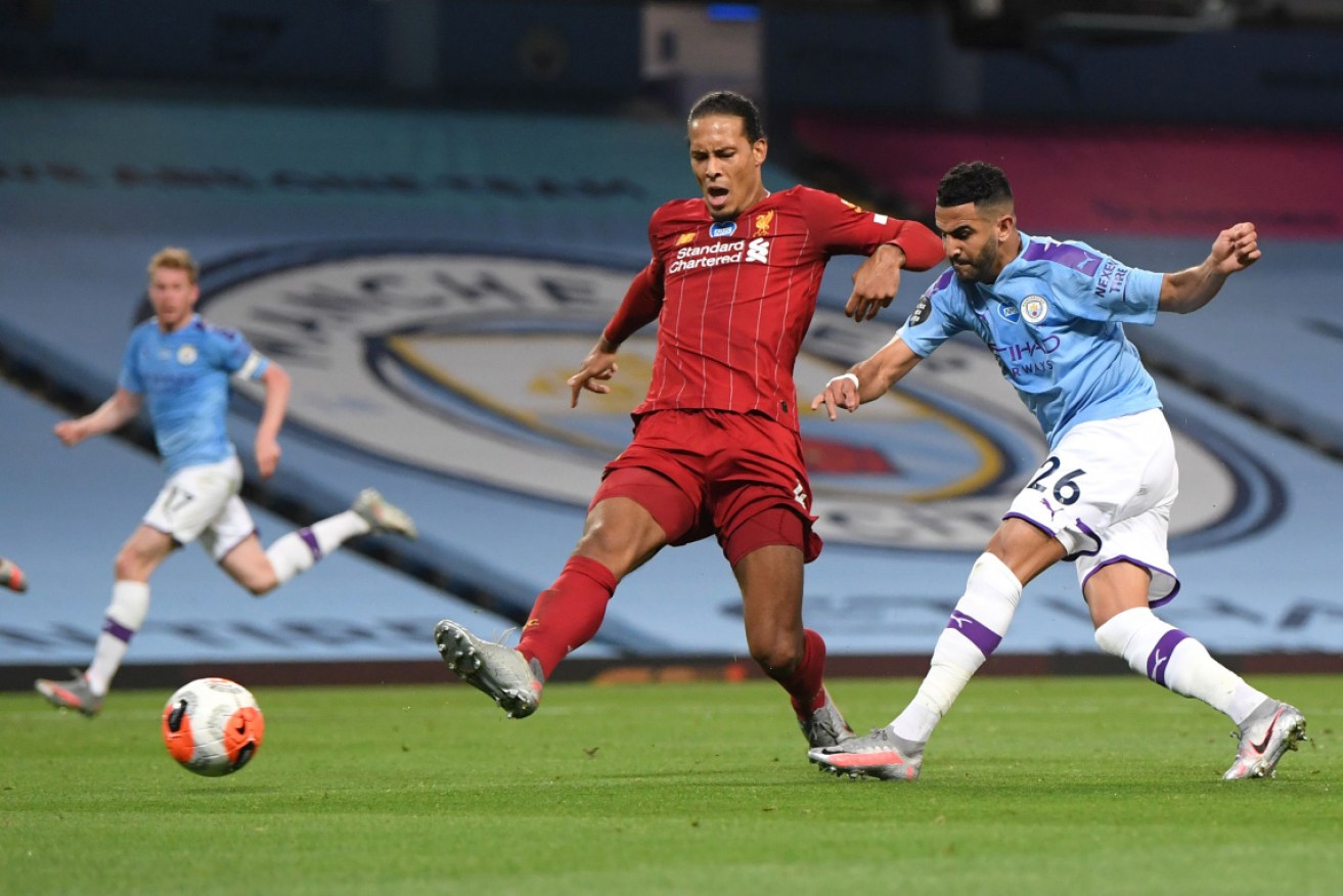 Manchester City's Riyad Mahrez is challenged by Liverpool' Virgil van Dijk.