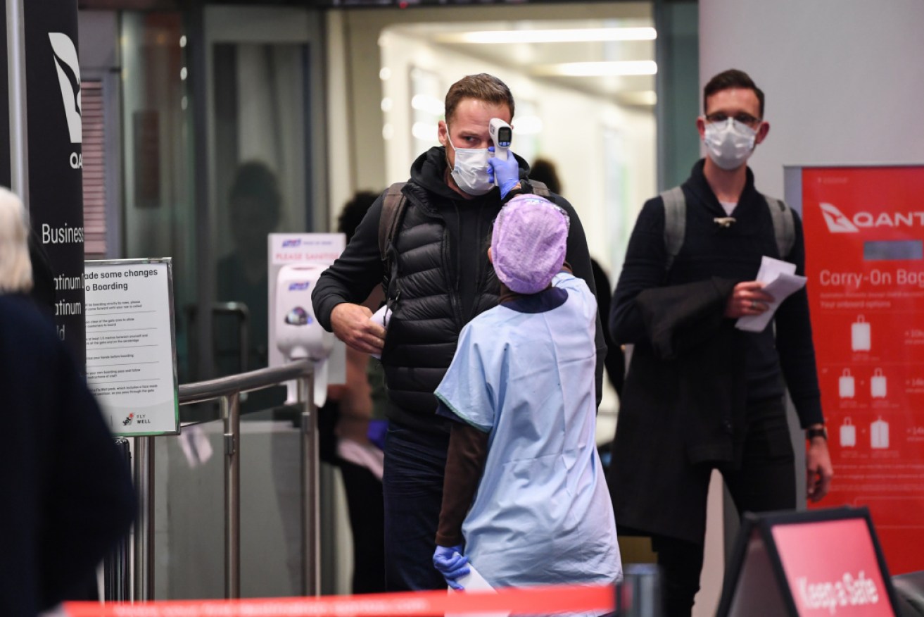 Passengers arriving from Melbourne have their temperature checked at Sydney airport.