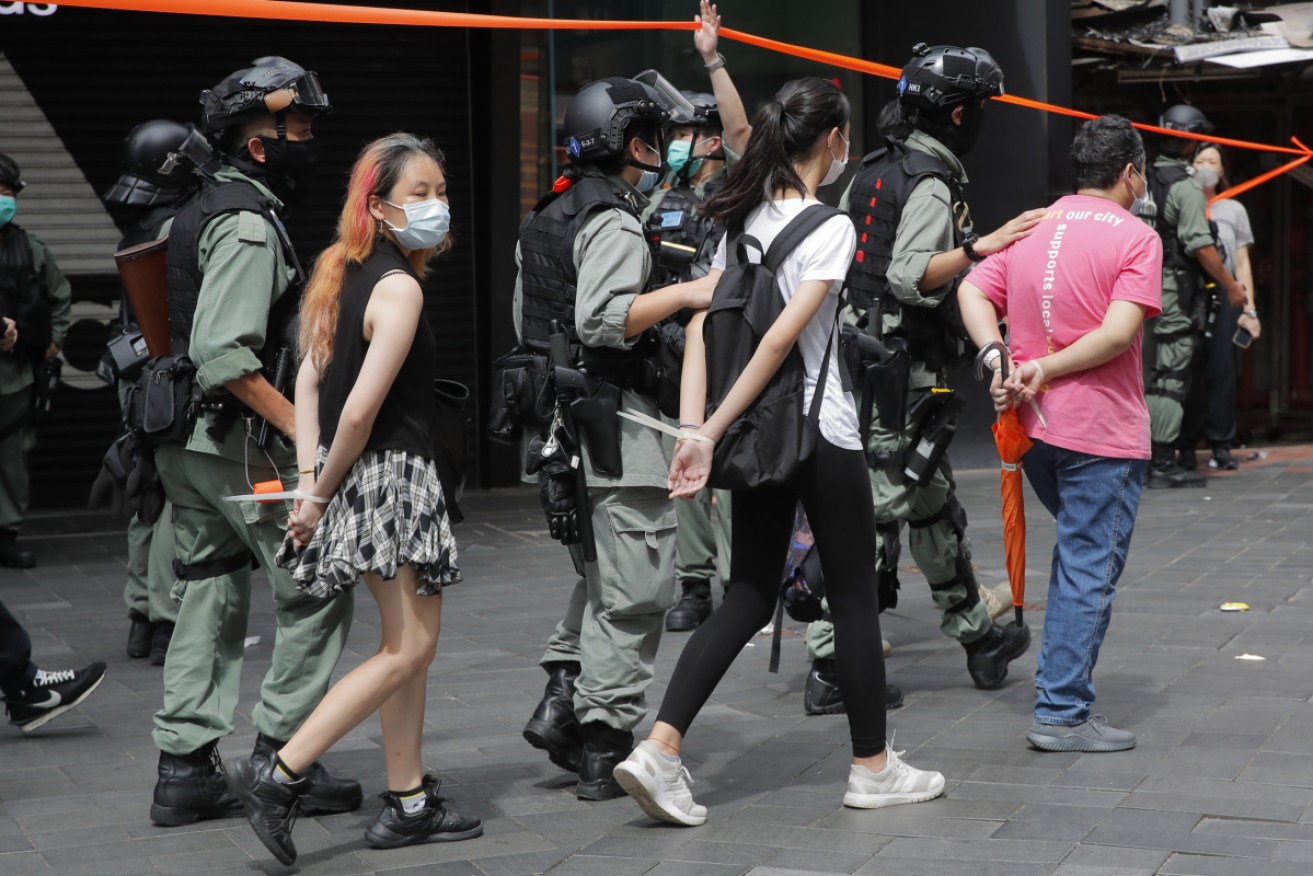 Police detain protesters after a protest in Causeway Bay before the annual handover march in Hong Kong on Wednesday.  