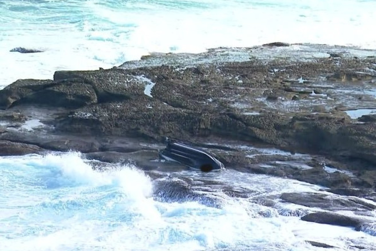 The overturned boat on the La Perouse coastline on Sunday.