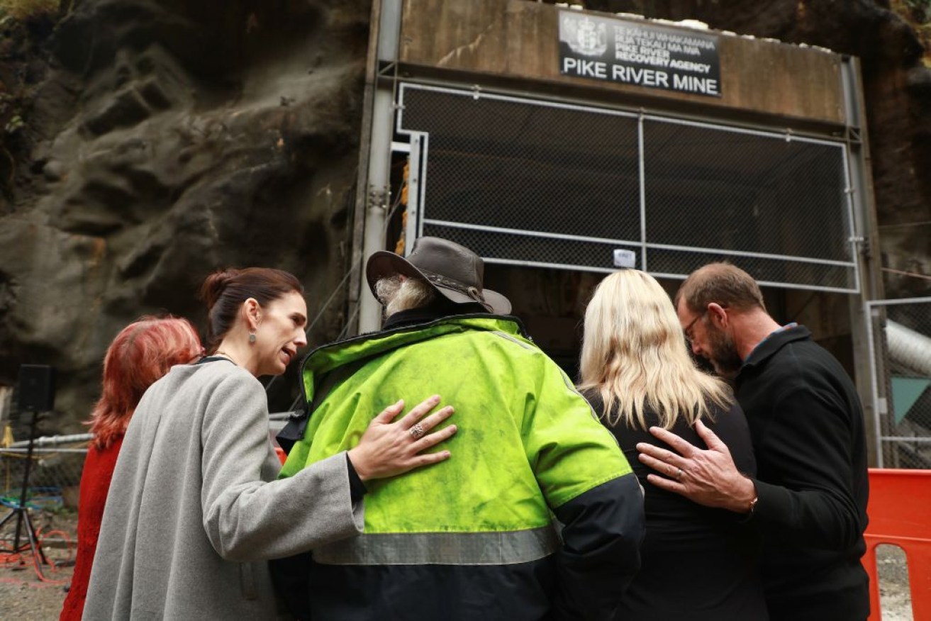 NZ PM Jacinda Ardern with grieving families outside the entrance to the Pike River mine in 2019.