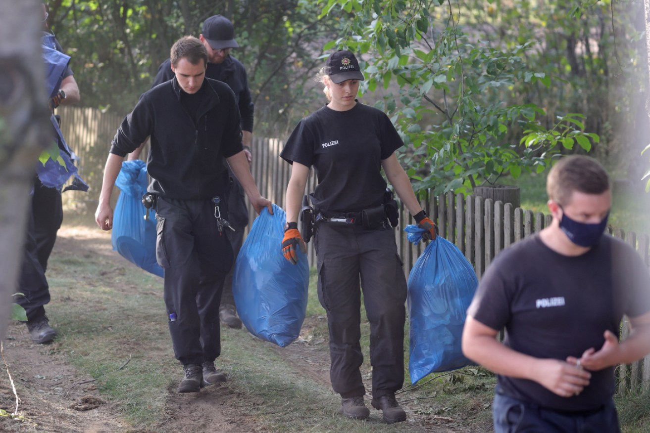 Police leave the operation site after searching a garden plot in Hannover, northern Germany.