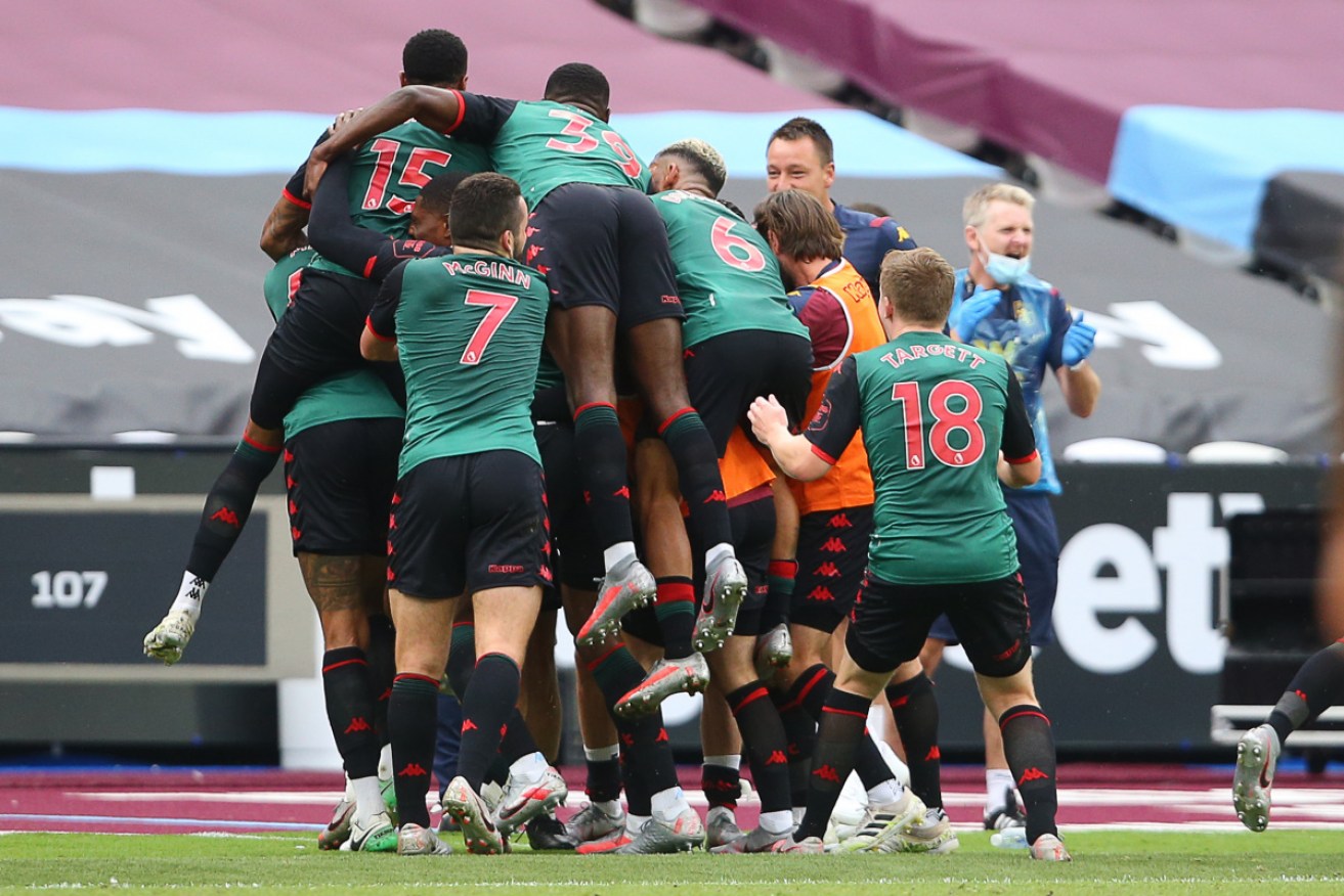 Aston Villa players mob captain Jack Grealish after his goal against West Ham ensured the club's survival.