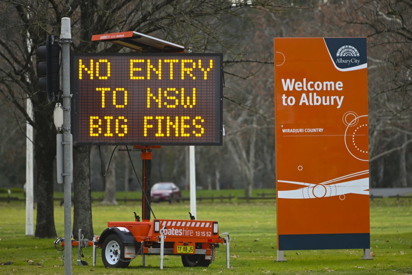 A sign displays COVID-19 restrictions in the NSW-Victoria border town of Albury. 