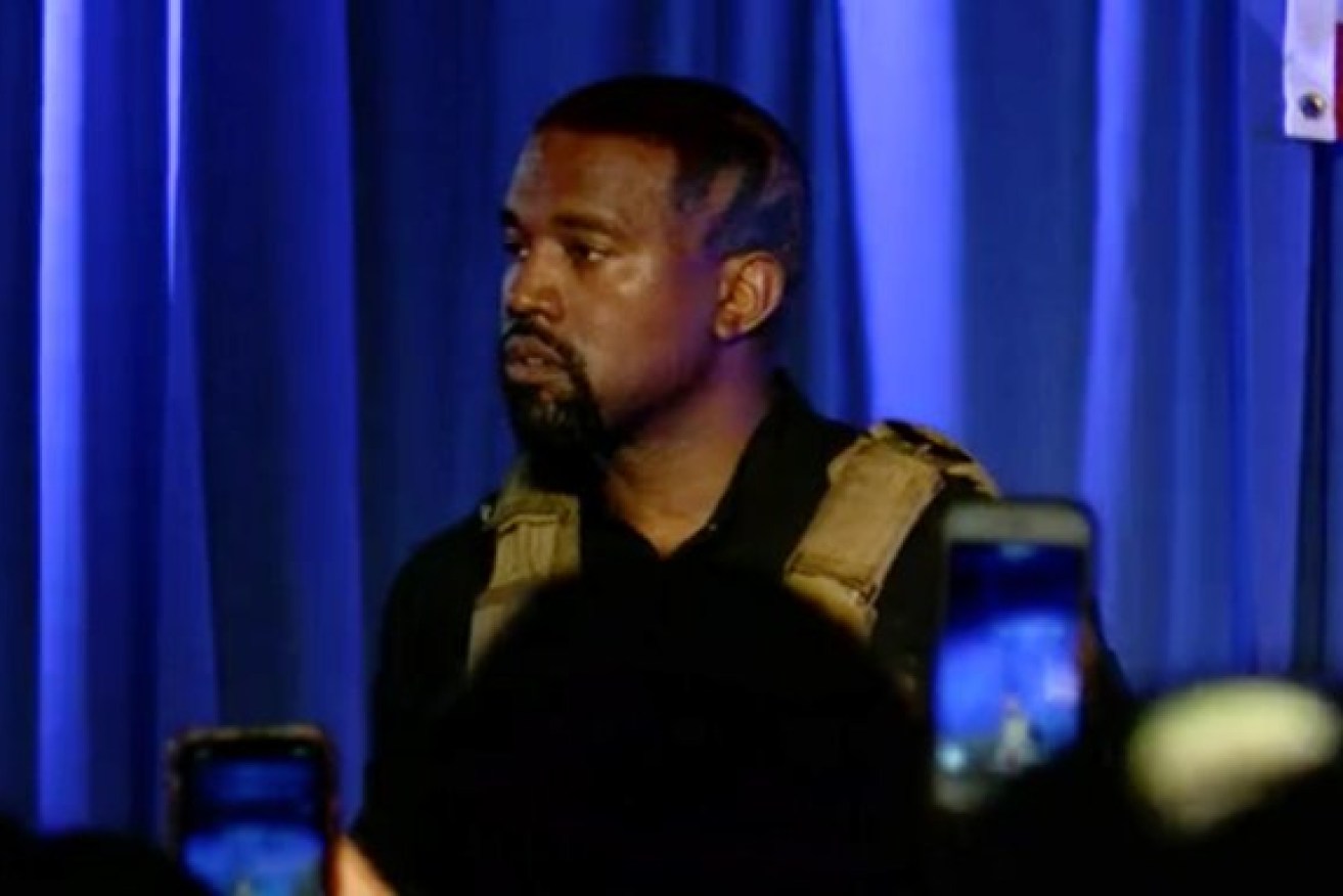 Wearing a bullet-proof vest, Kanye West delivered rambling remarks at his first rally for his last-minute US presidential campaign.