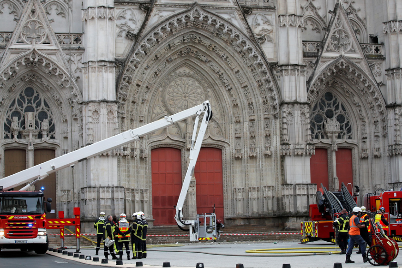 French firefighters mop up after saving historic Nantes cathedral.