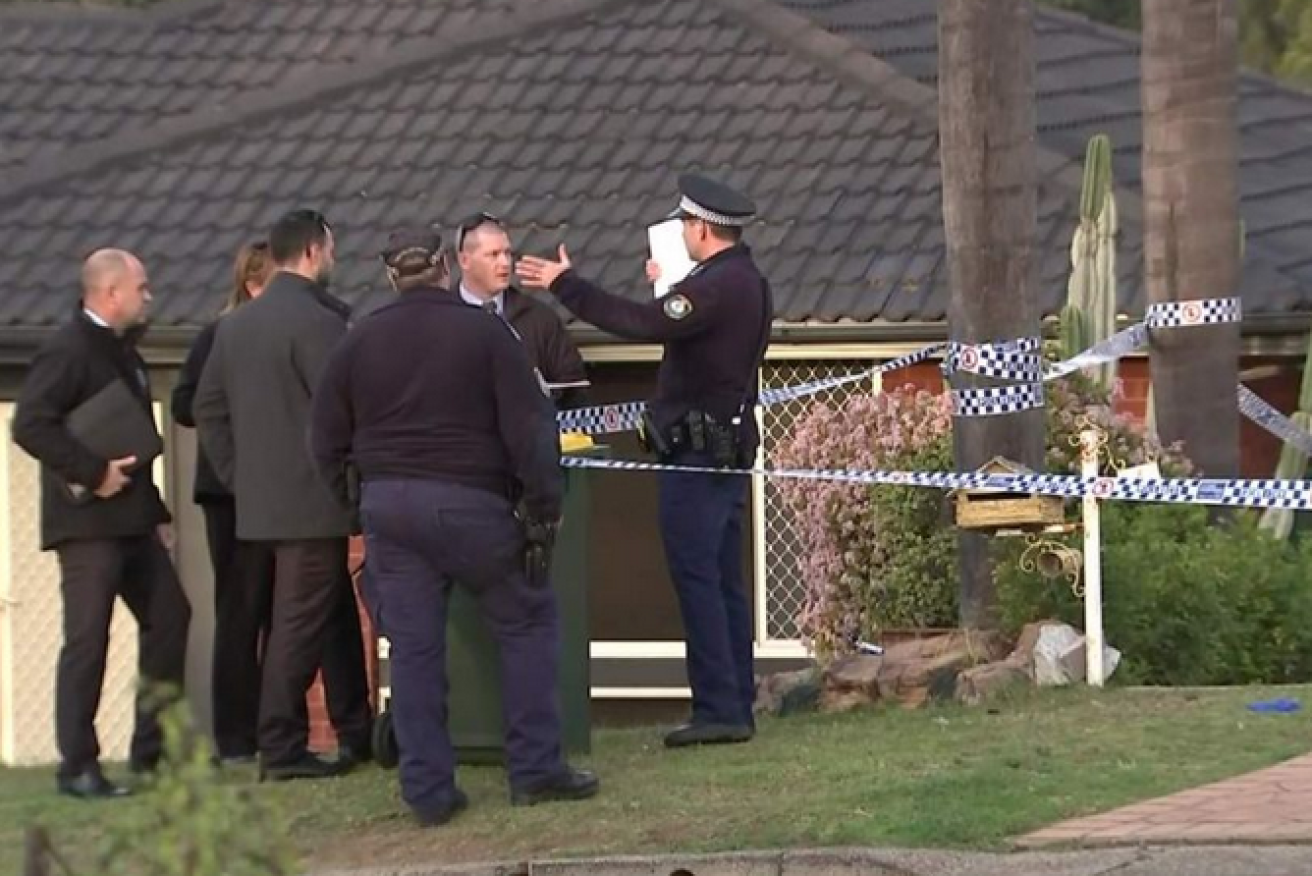 Police begin their investigation outside the home in Casula.