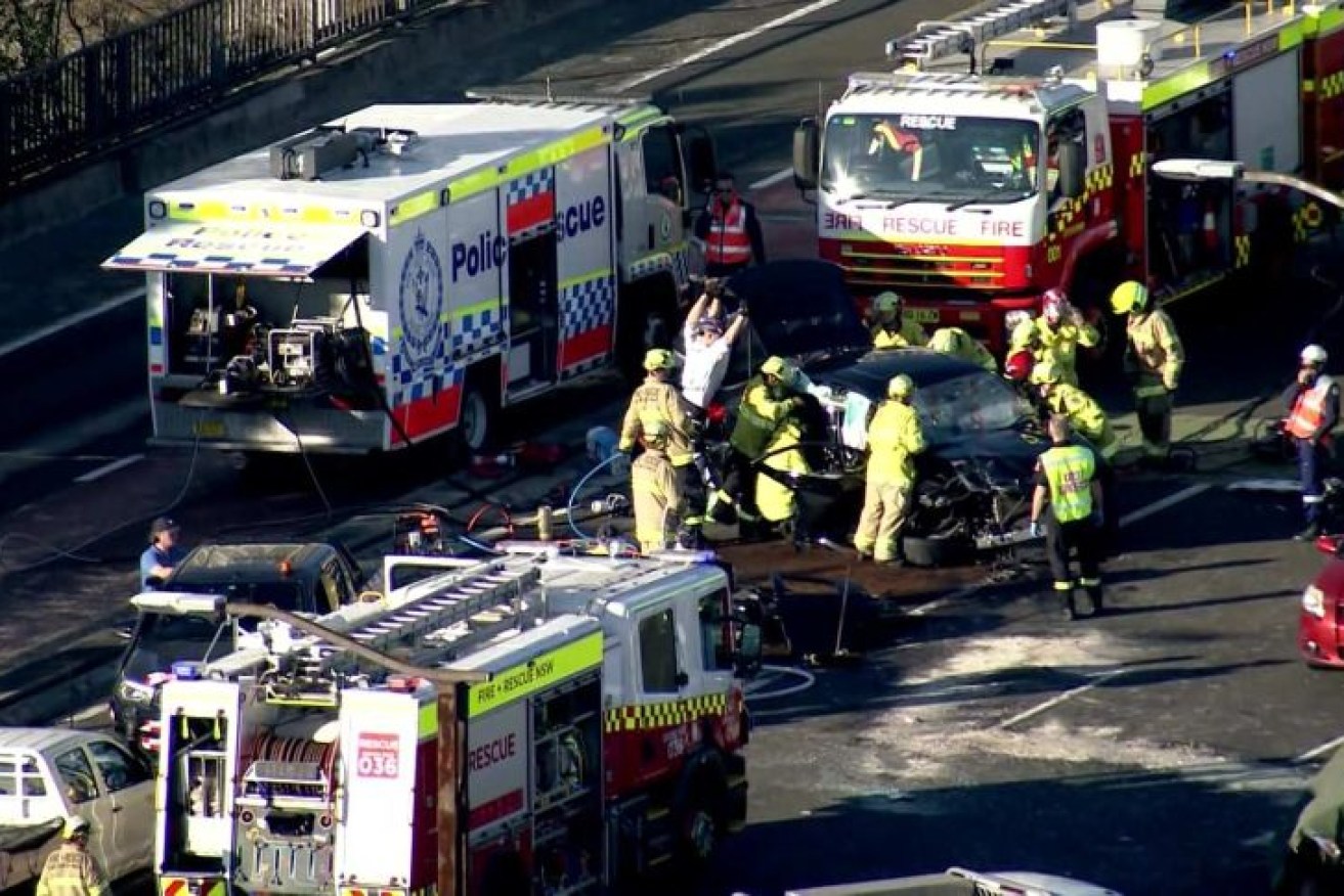 First responders attempt to free a trapped driver on the bridge.