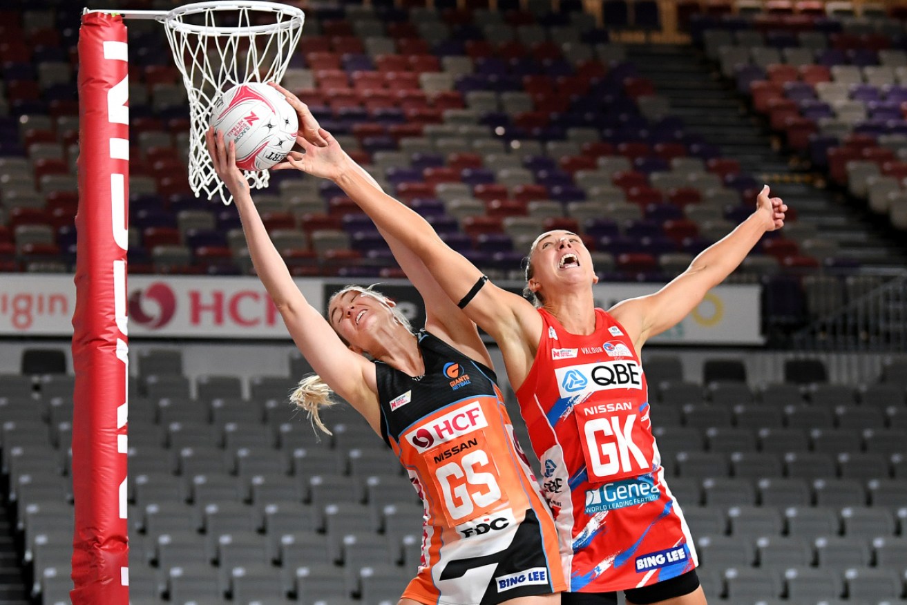Caitlin Bassett of the Giants and Sarah Klau of the Swifts compete for the ball in Brisbane. 