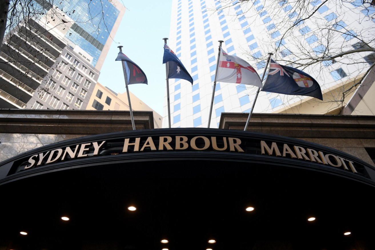 Two guards from the Sydney Harbour Marriott have tested positive to the virus.
