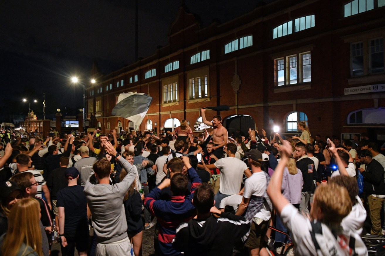 Fulham supporters gather outside their team's Craven Cottage football stadium to celebrate the club's promotion to the EPL.