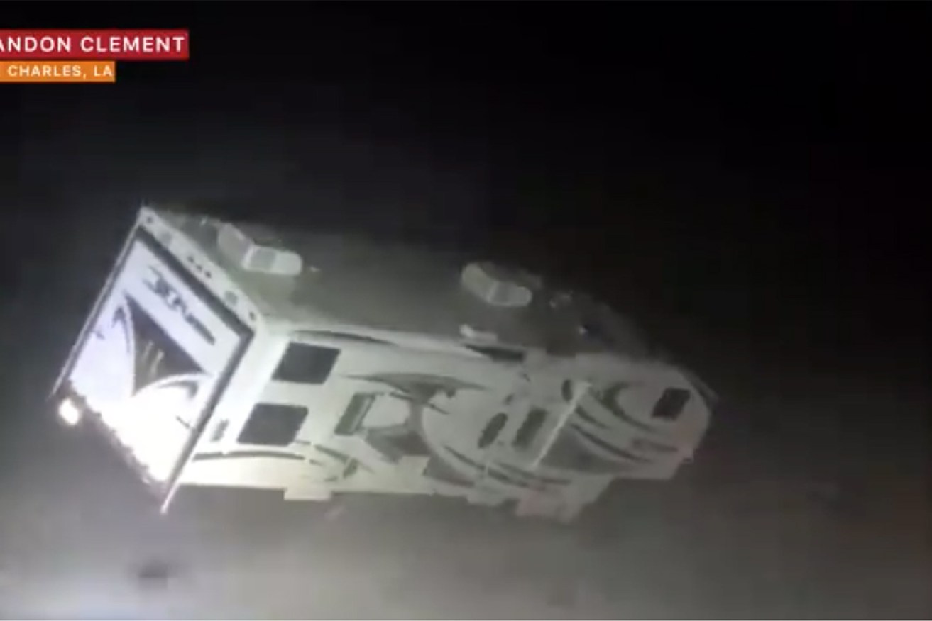 A recreational vehicle at Lake Charles is blown over by the winds.