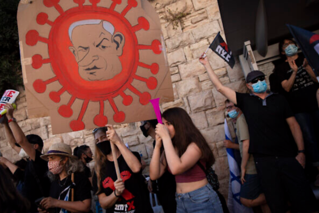 Protesters in Israel liken PM Benjamin Netanyahu to the coronavirus.