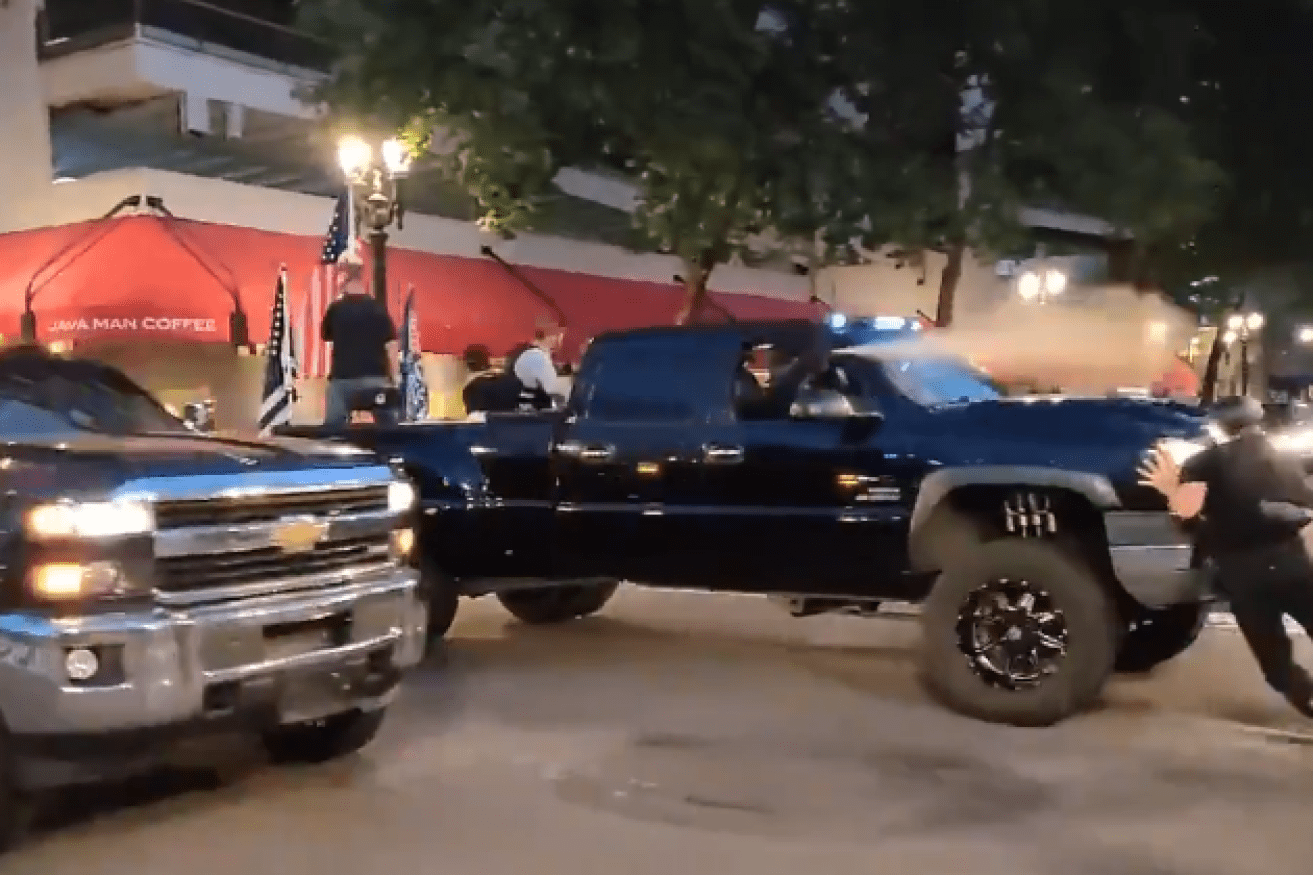 Their pickups draped with the US flag, Donald Trump's supporters barrel through the BLM crowd.