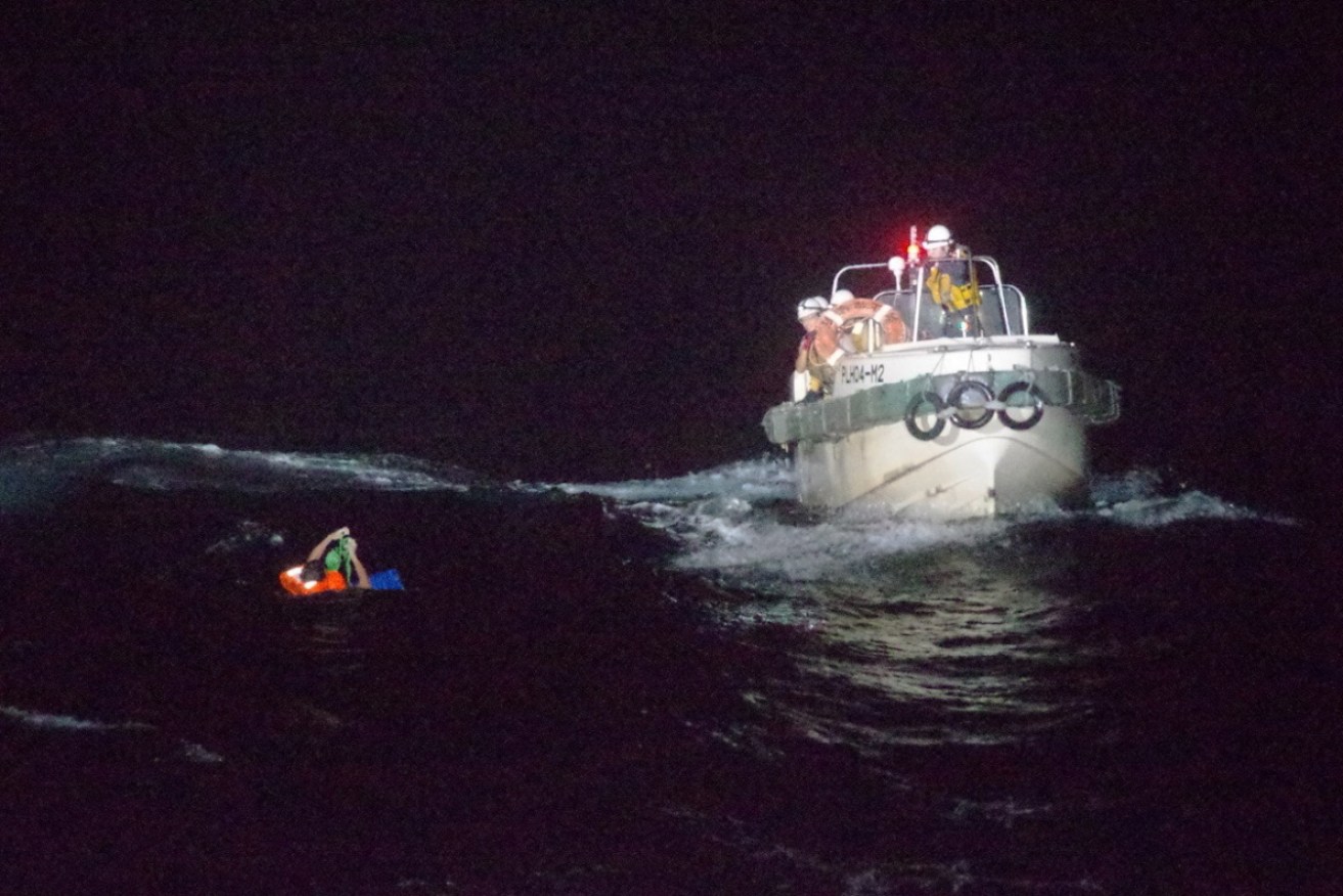 Japan Coast Guard officers rescue the crew member.