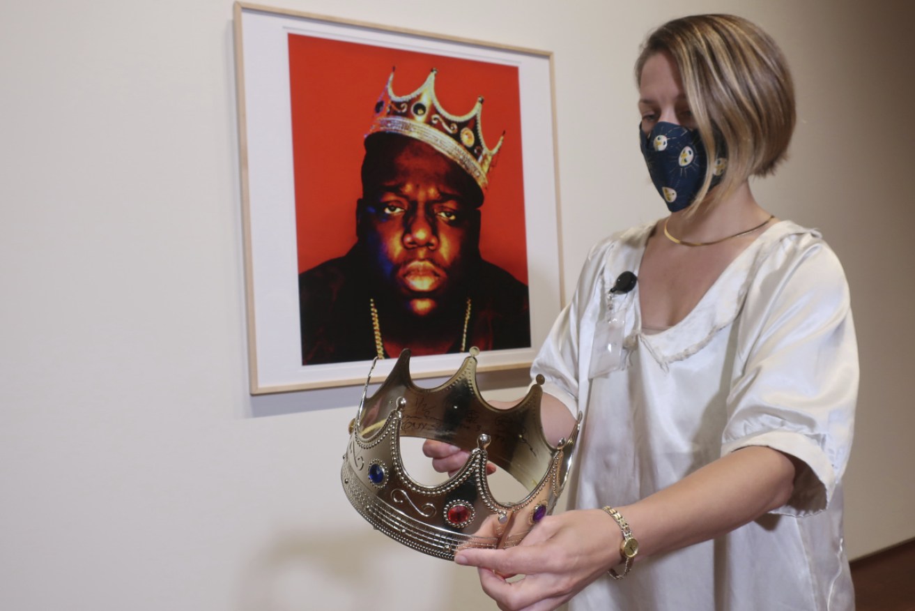 
Sotheby's specialist Cassandra Hatton holds the plastic crown worn and signed by Notorious B.I.G.