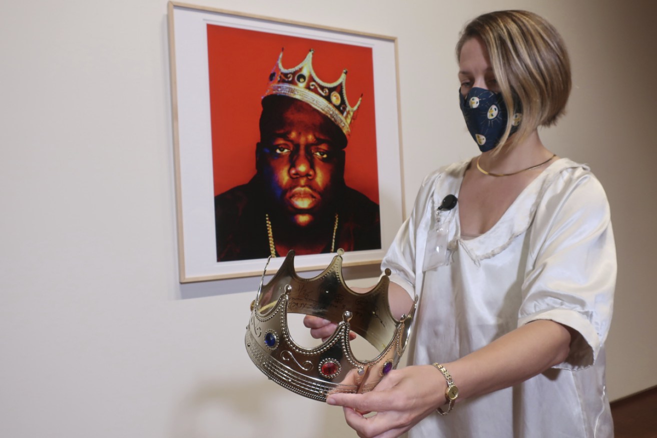 Sotheby's specialist Cassandra Hatton holds the plastic crown worn and signed by Notorious B.I.G.