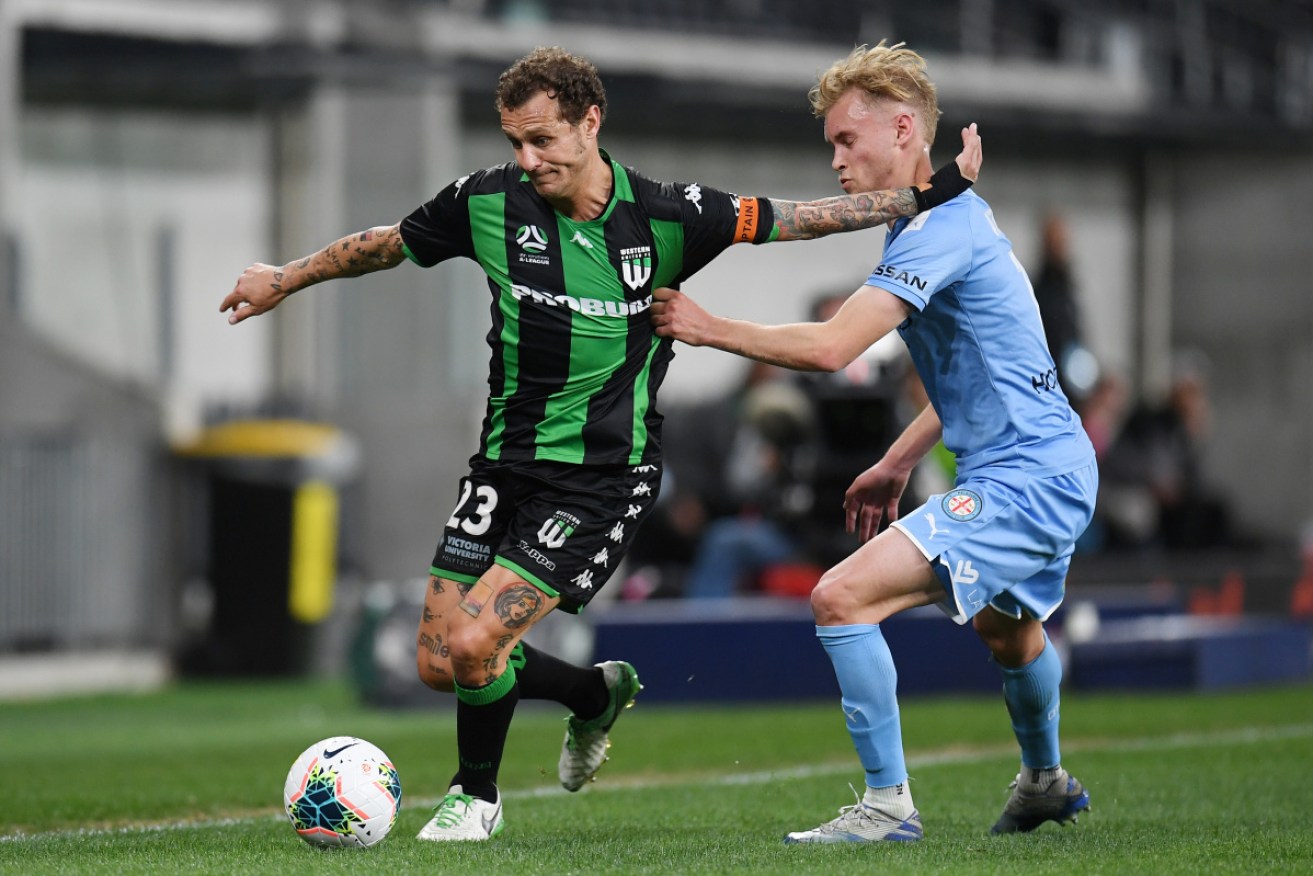 Western United’s Alessandro Diamanti keeps Melbourne City's Nathaniel Atkinson at bay.