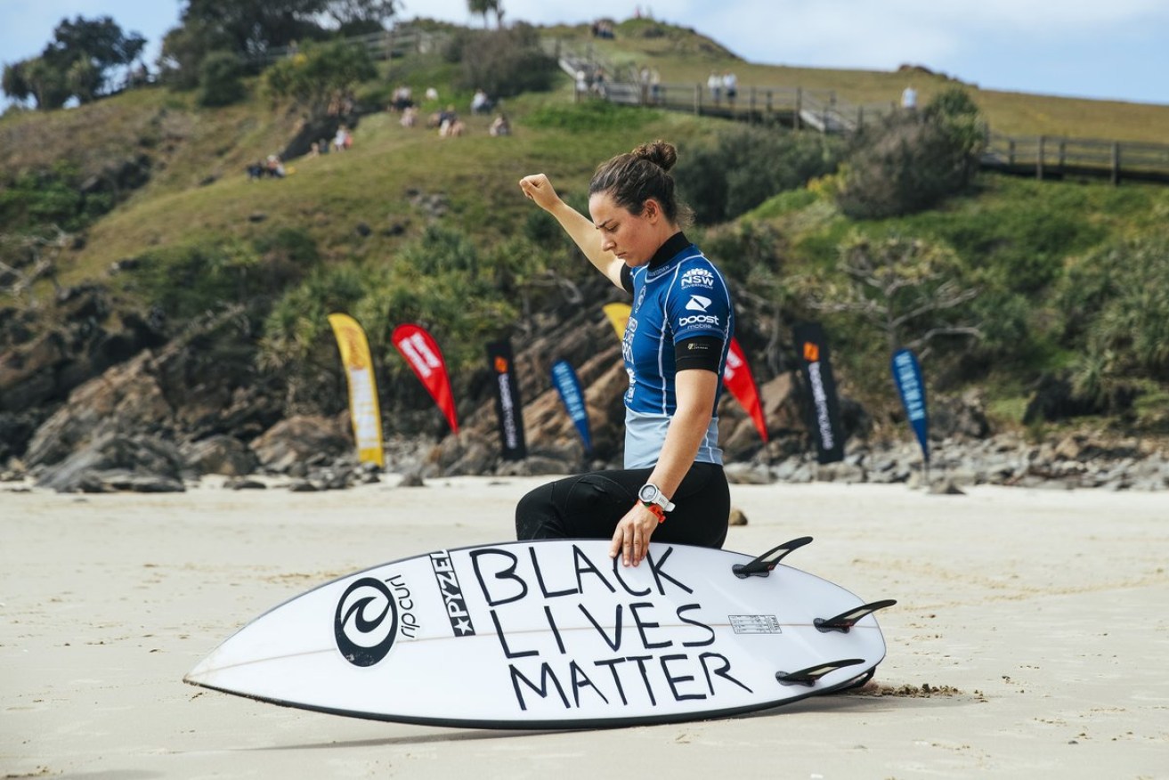 Aussie surfer Tyler Wright takes a knee for Black Lives Matter before the Tweed Pro event.