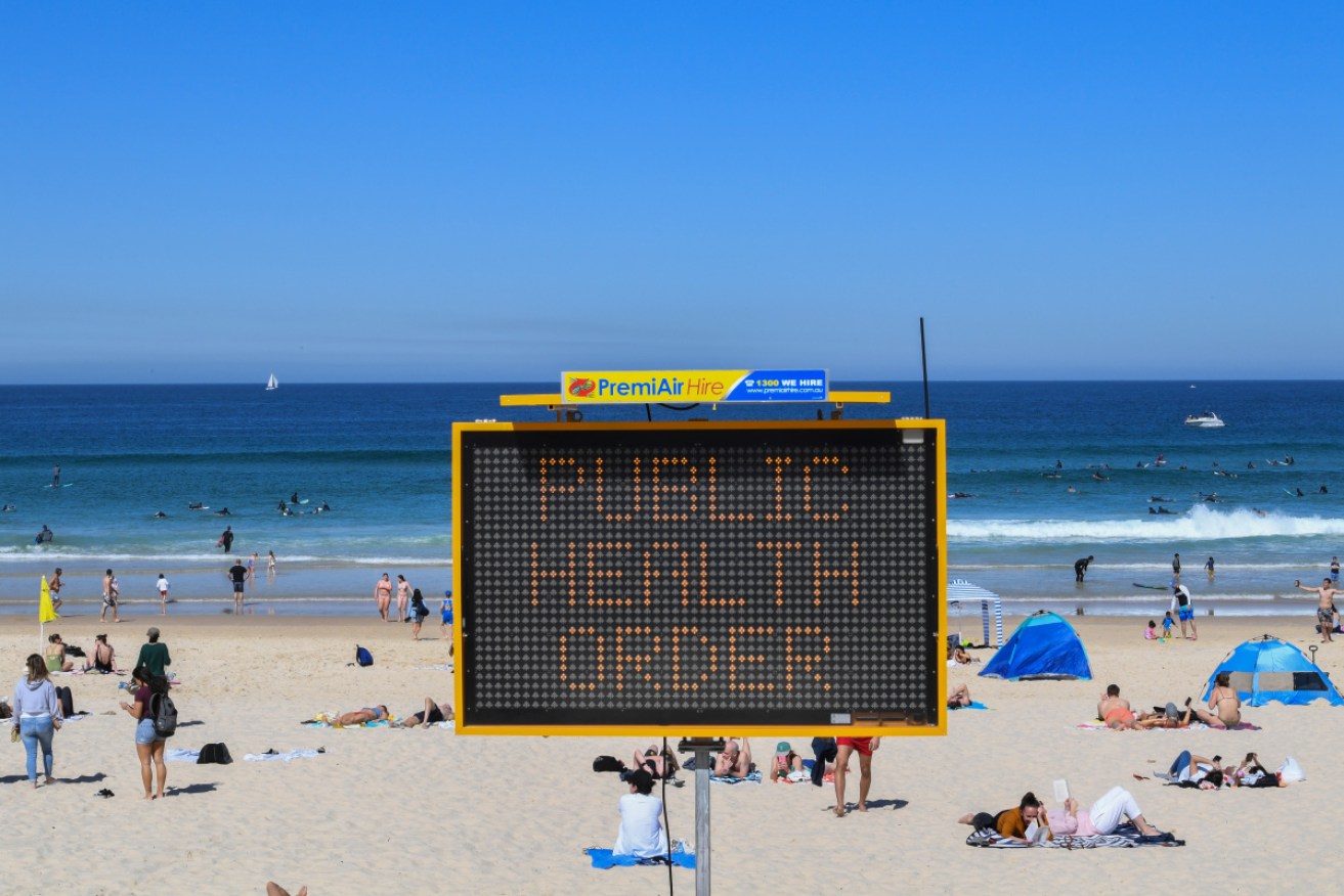 Beachgoers are urged to practise social distancing at Bondi Beach in Sydney. 