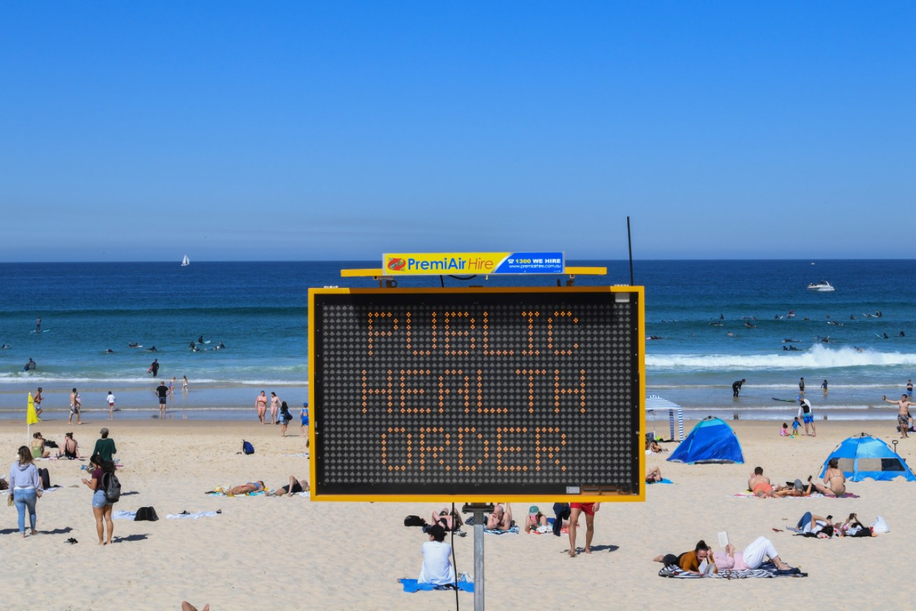 Beachgoers are urged to practise social distancing at Bondi Beach in Sydney.