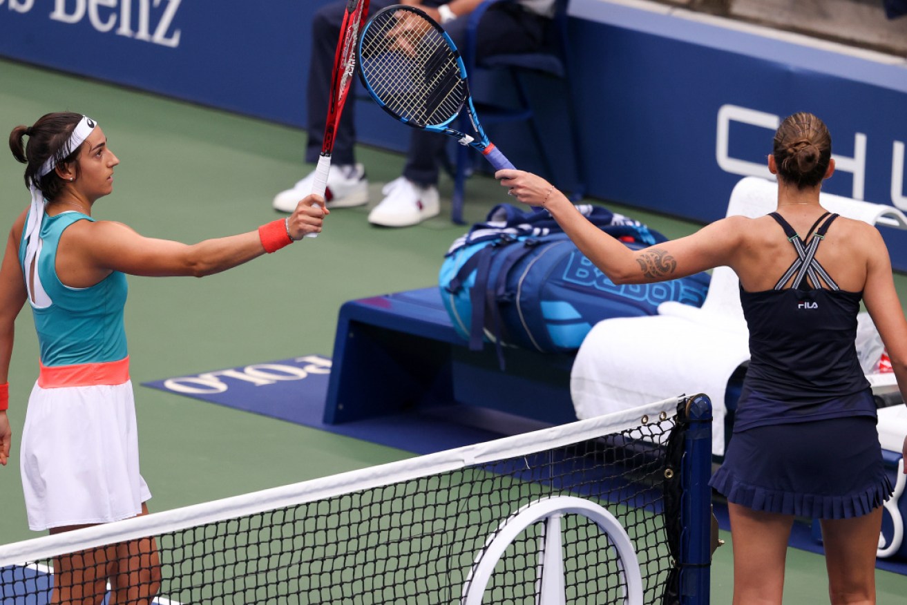 Caroline Garcia and Karolina Pliskova touch racquets after their second-round match.