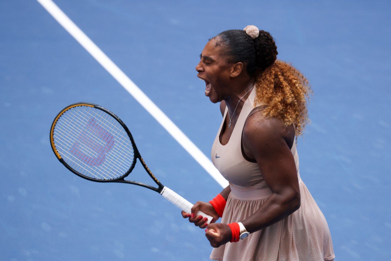Serena Williams celebrates winning match point against Maria Sakkari.