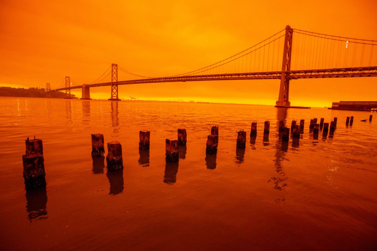 Smoky skies from the northern California wildfires casts a reddish colour on San Francisco's bay.