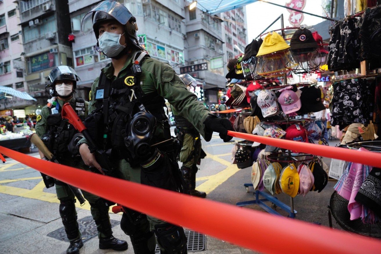 About 90 people were arrested on Sunday as police stand guard in Hong Kong.  