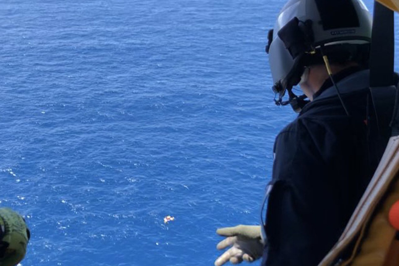 The rescue helicopter hovered above the group, who were all in the water, until they were safely aboard the bulk carrier.