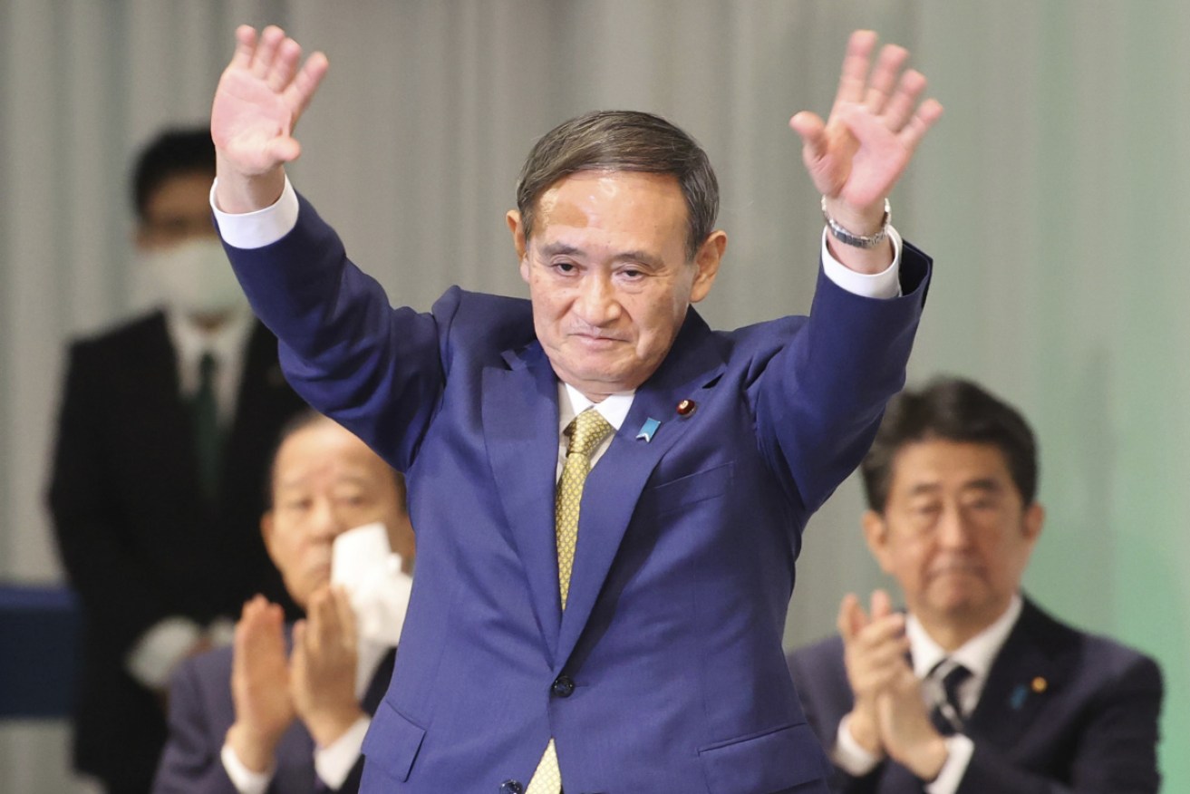 Yoshihide Suga waves after winning the Liberal Democratic Party presidential election in Tokyo on Monday. 