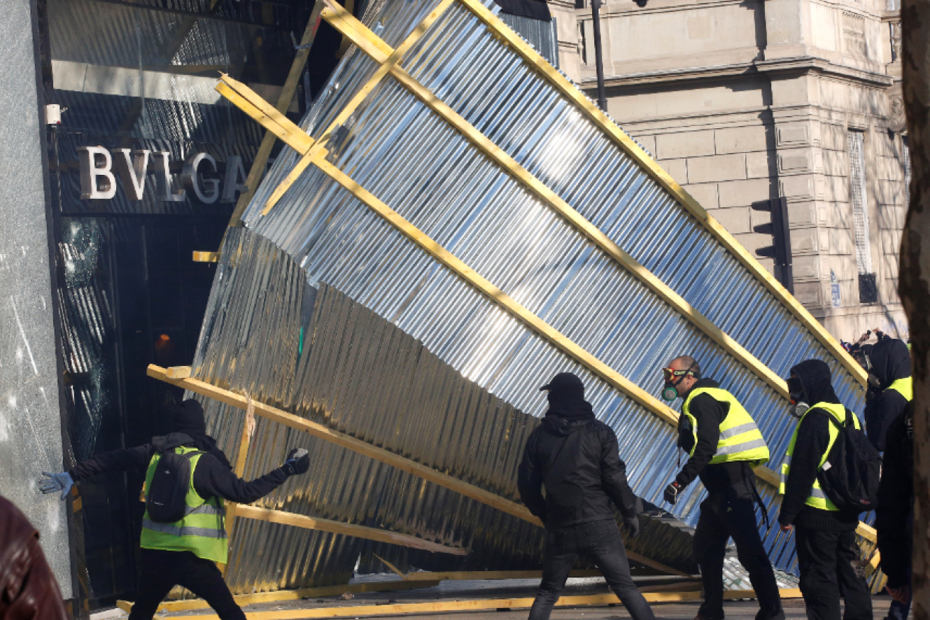 Looters tear down the barricade outside the Bulgari jewelry store in the heart of Paris. 