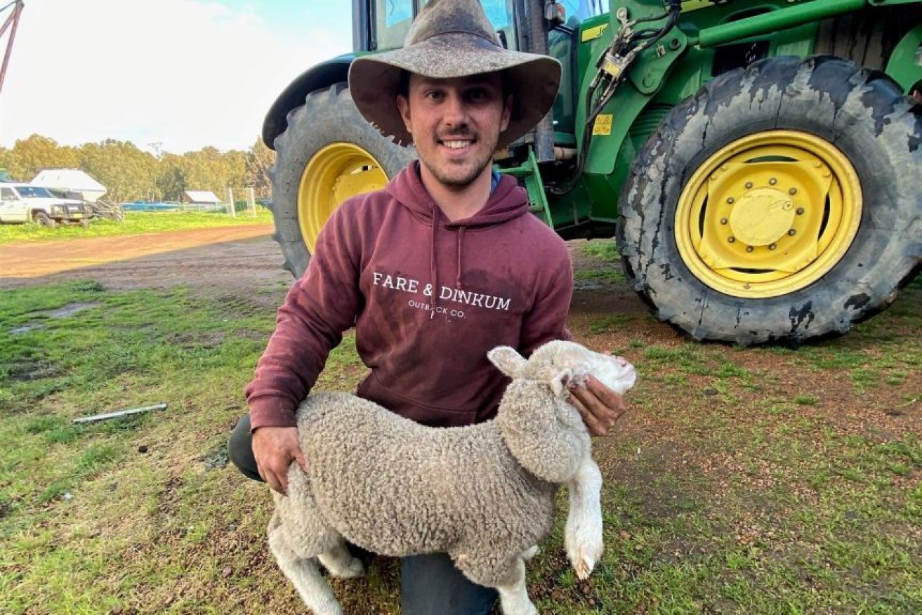 Kojonup farmer Marshall Bowey with his five-legged lamb. 