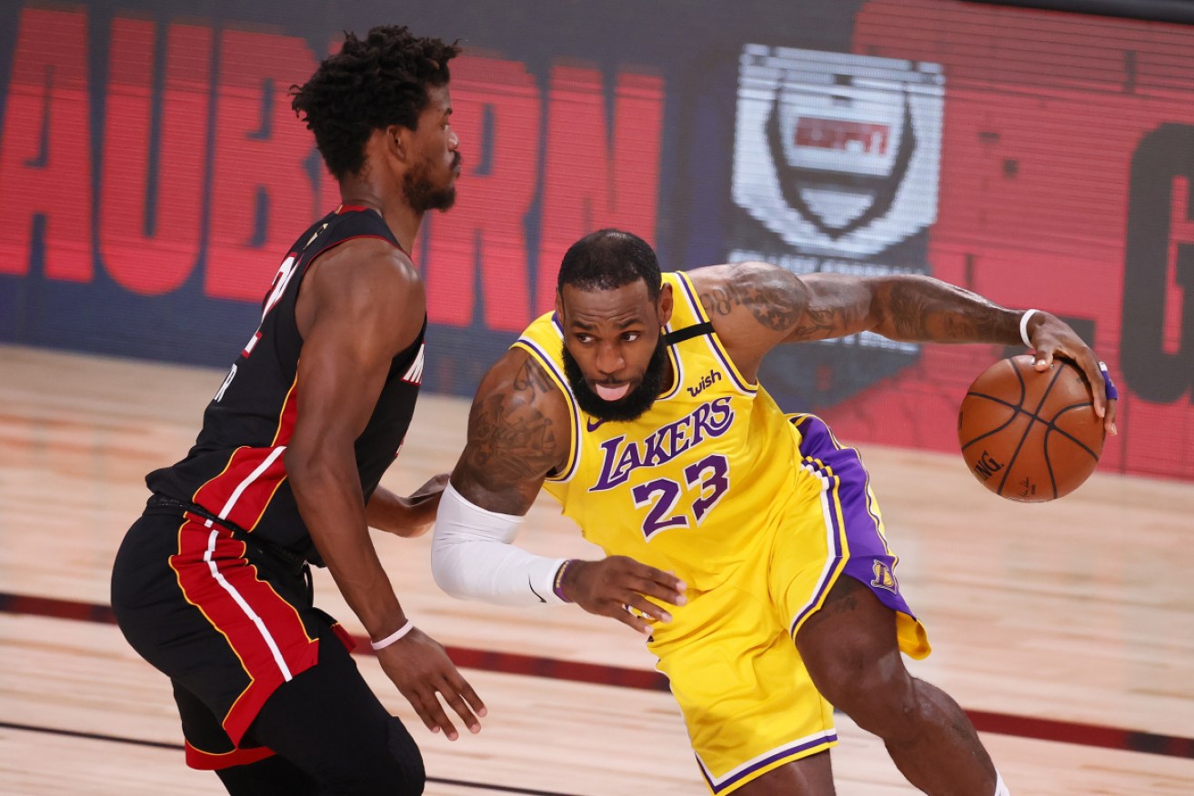 The Lakers' LeBron James drives against the Heat's Jimmy Butler.