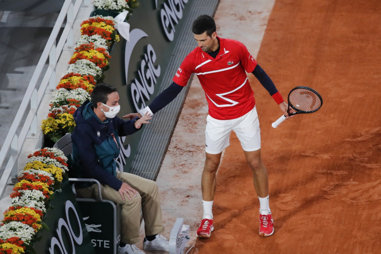 Novak Djokovic checks on the linesman who was hit by a stray ball from his racquet.