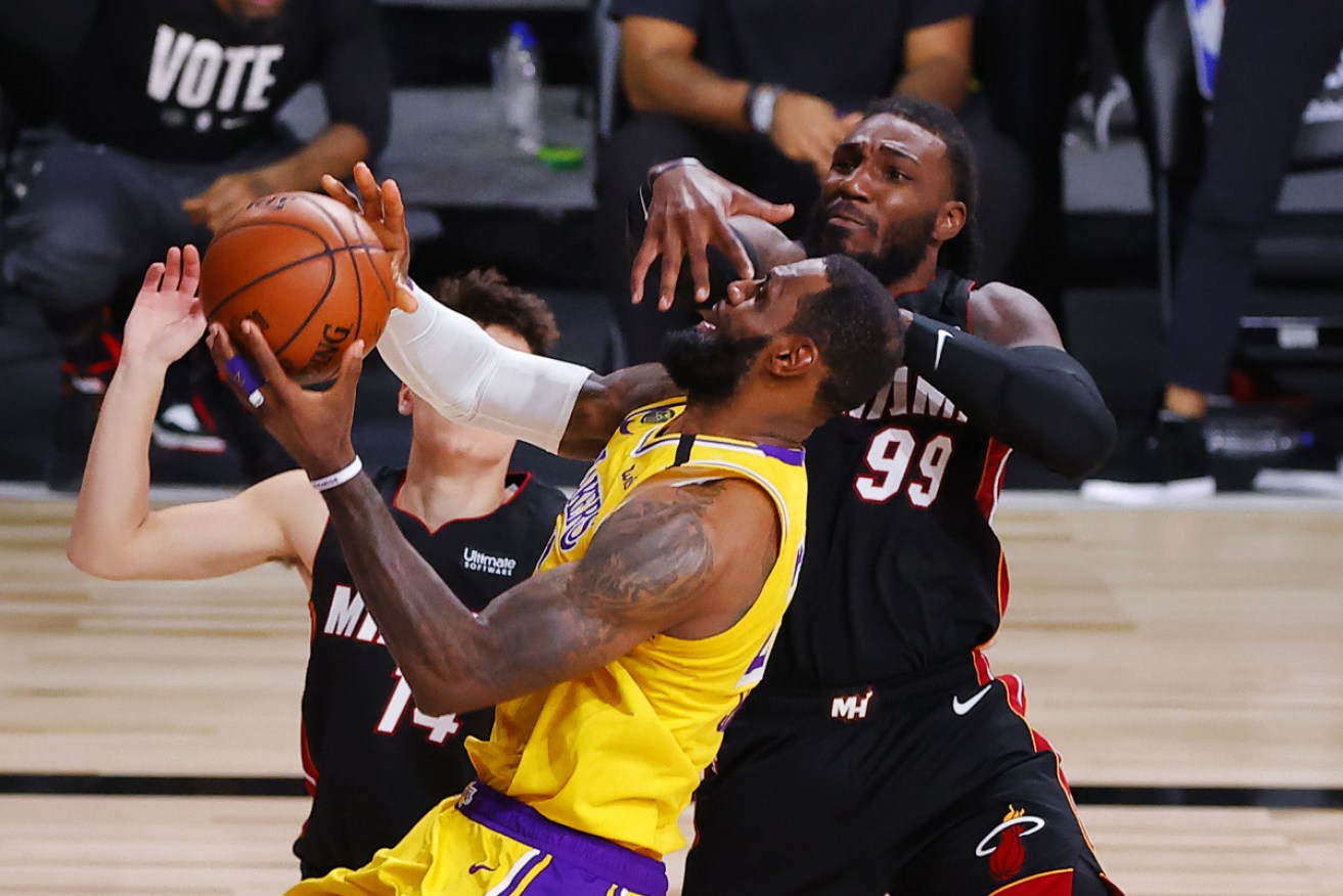 Miami Heat's Jae Crowder, right, defends Los Angeles Lakers' LeBron James.