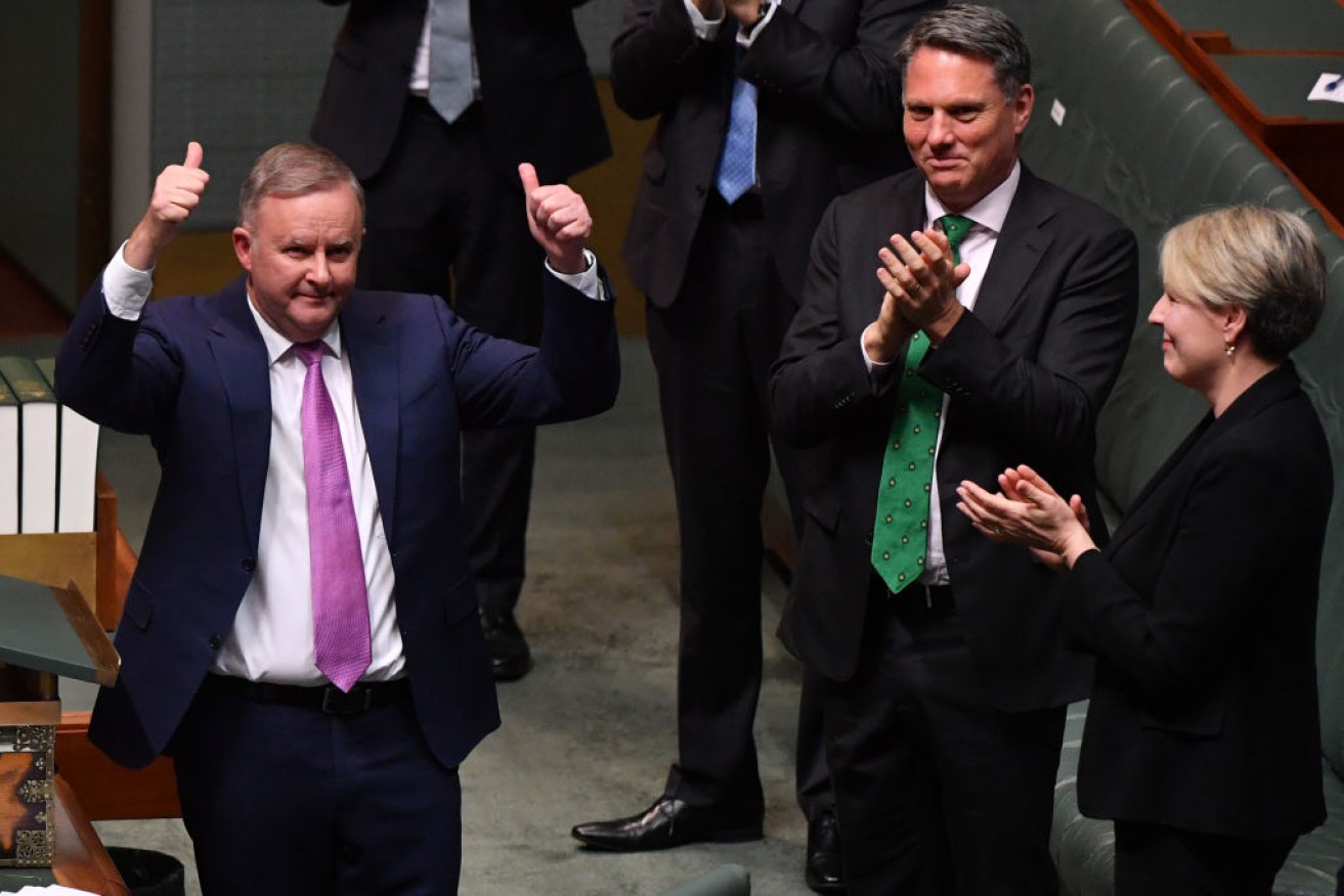 Anthony Albanese receives applause from deputy Richard Marles and Education spokeswoman Tanya Plibersek after delivering his budget reply speech. Photo: Getty