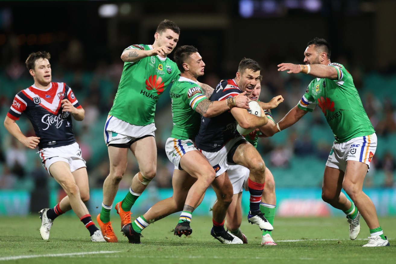 The Raiders' James Tedesco is tackled during the semi-final against the Sydney Roosters.