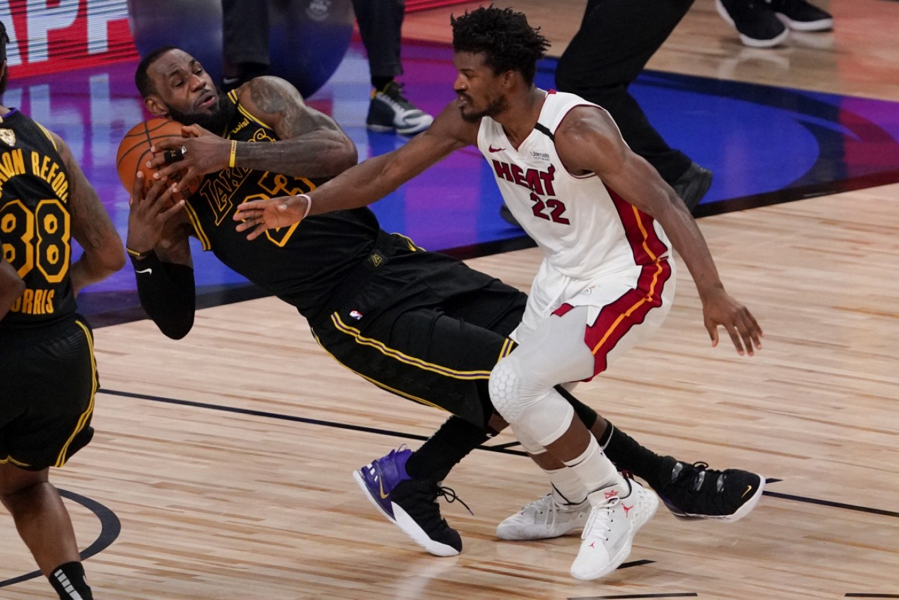 Los Angeles Lakers forward LeBron James, left, up against Miami Heat forward Jimmy Butler