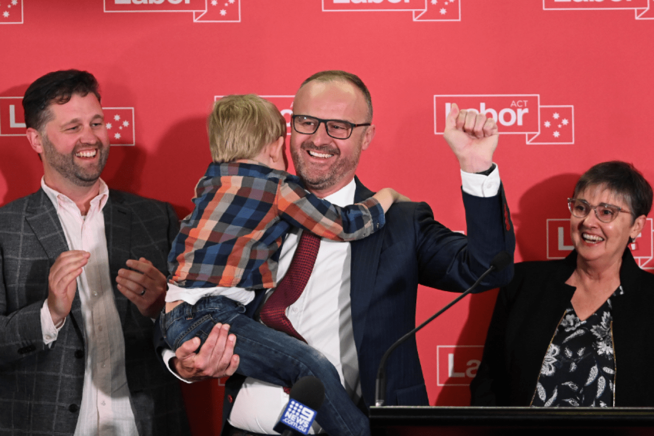 ACT Chief Minister Andrew Barr gets a hug from nephew Angus as he celebrates Labor's triumph.