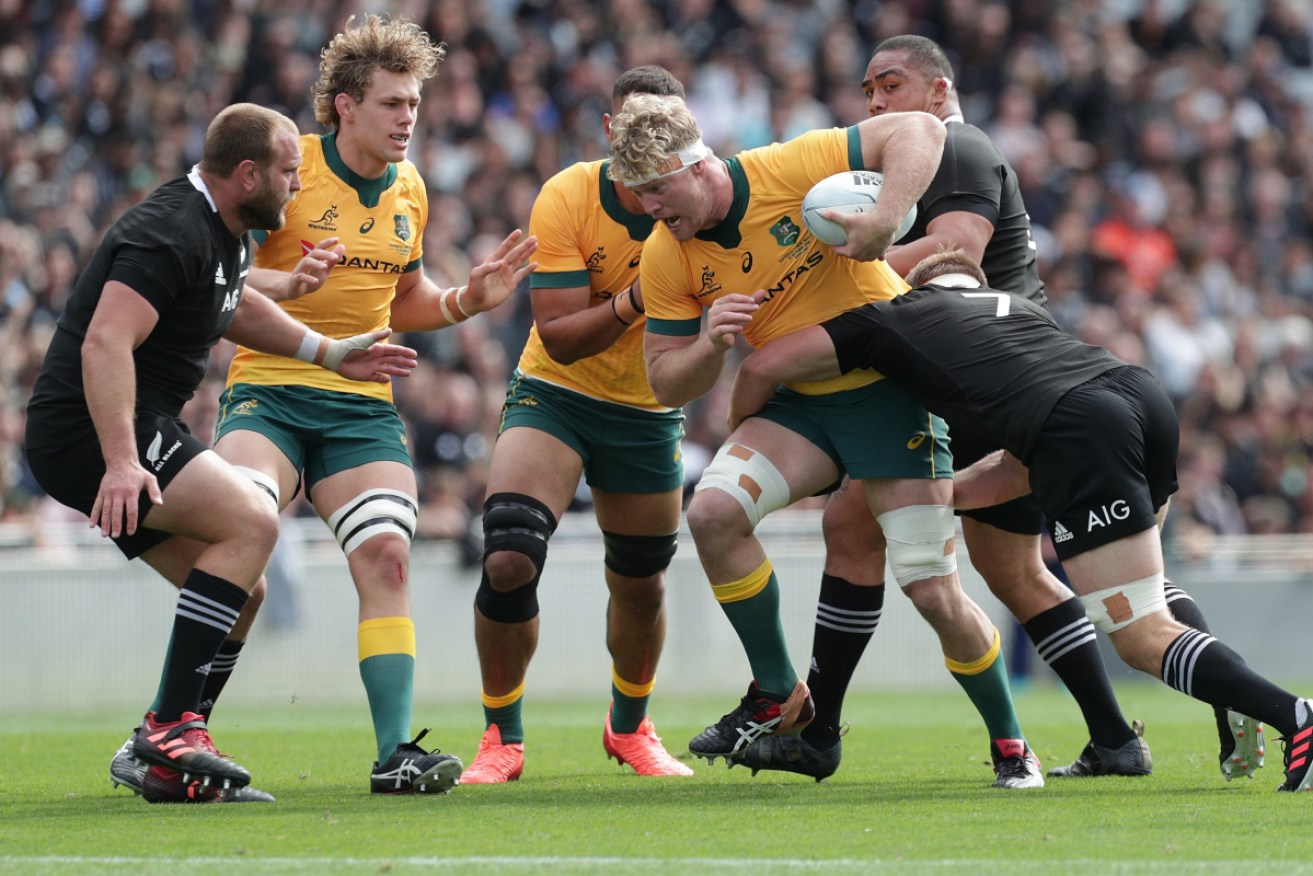 Matt Philip of Australia is tackled by All Black skipper Sam Cane.