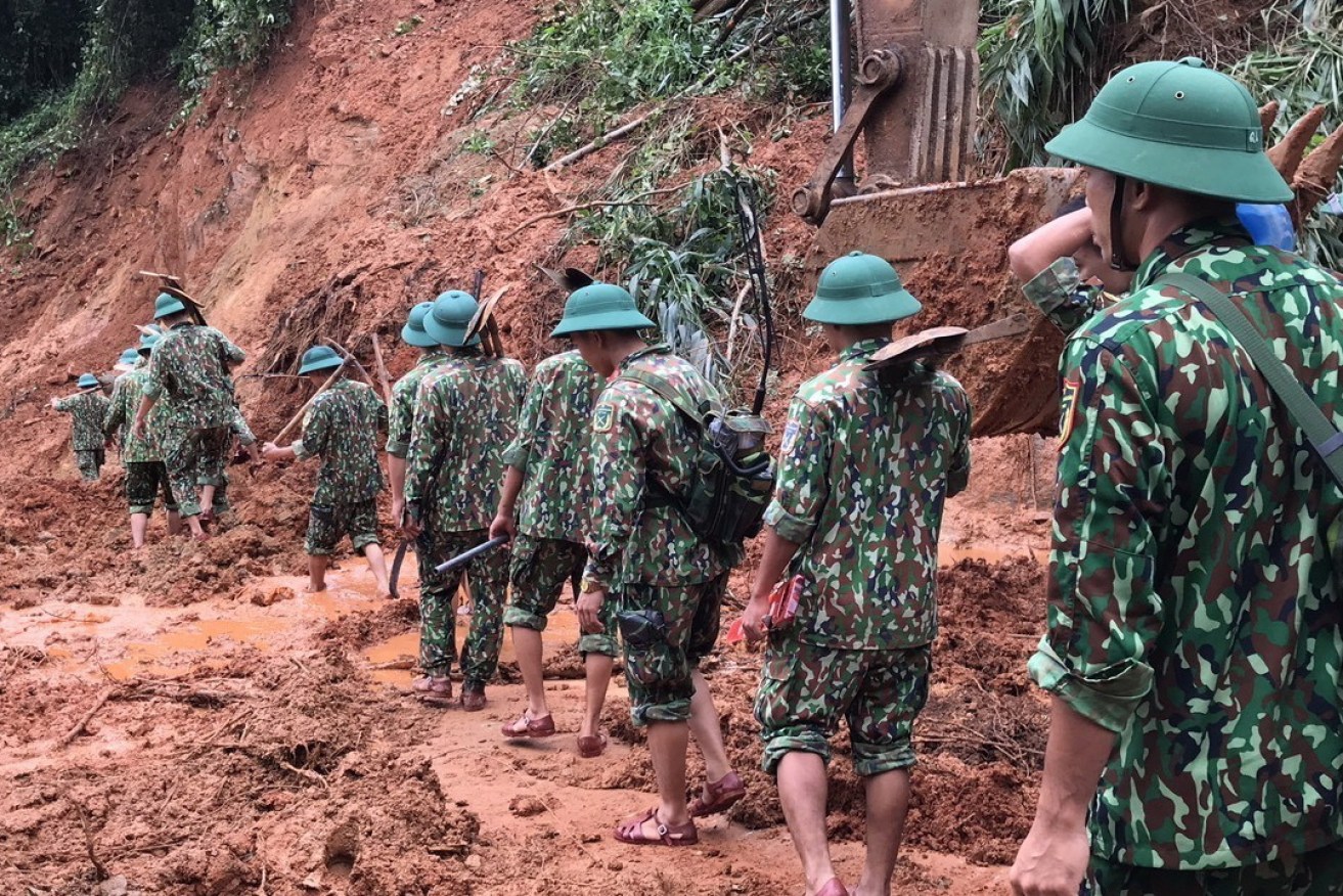 Rescue workers search for missing people after a landslide left at least 22 soldiers missing in Vietnam's Quang Tri province.